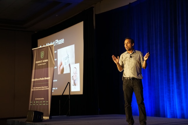 A man presenting on stage