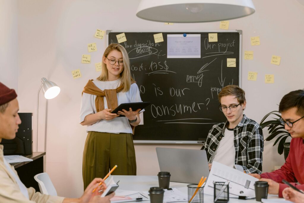 a women in white shirt is presenting to her group