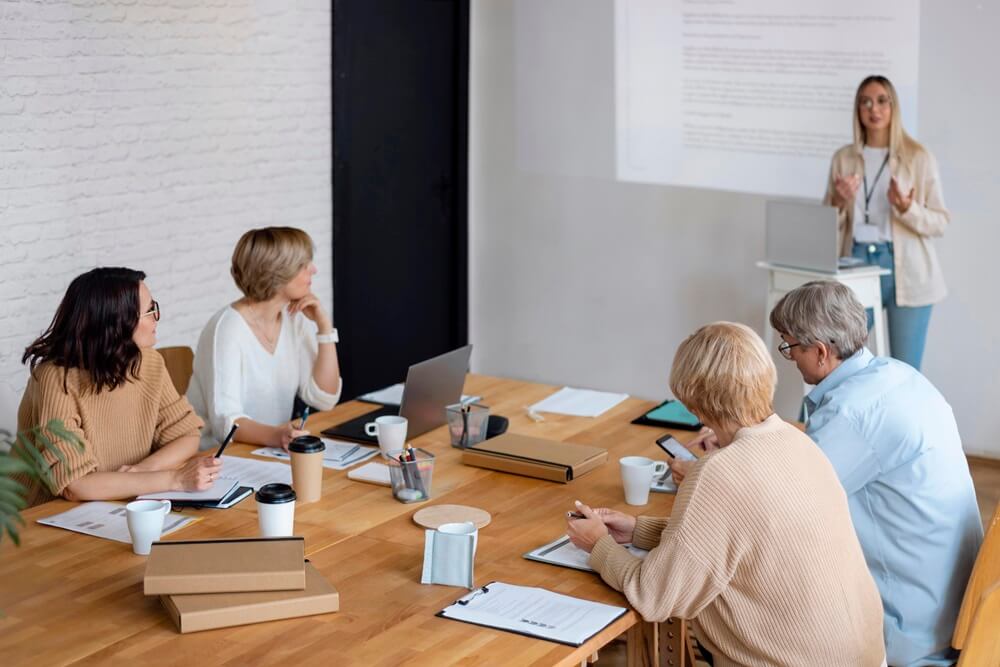 women presenting in frint of business leaders