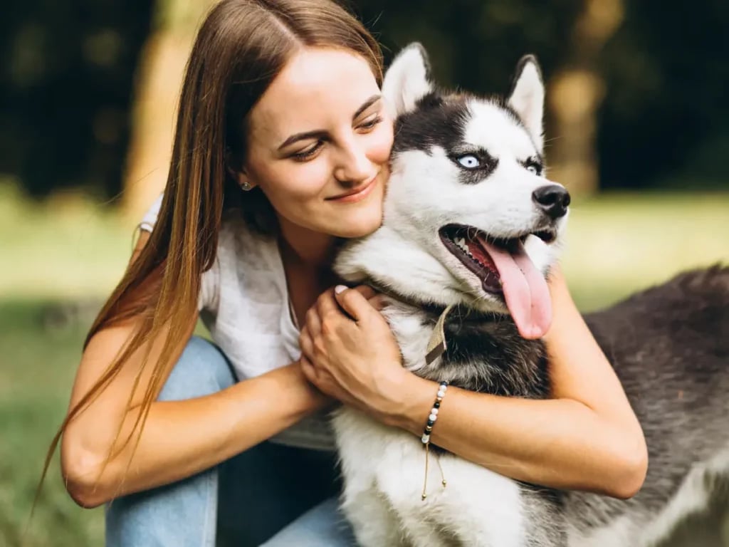 girl hugging husky